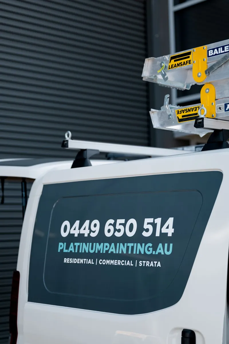 Rear of the Platinum Painting van showing the phone number and website