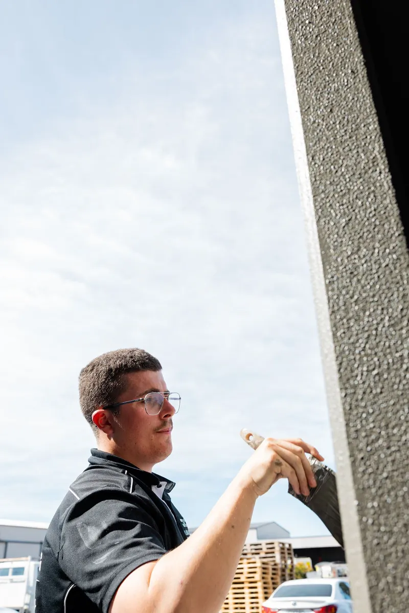 Platinum painter assessing a wall before quoting