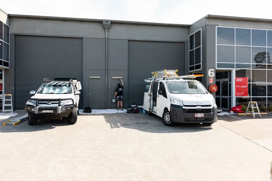 Platinum Painting branded vans on site at a commercial complex in Beresfield