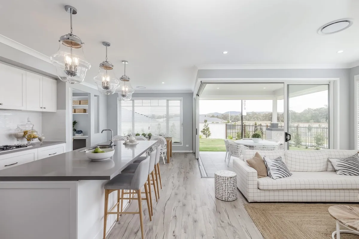 Open plan kitchen and living painted in warm whites
