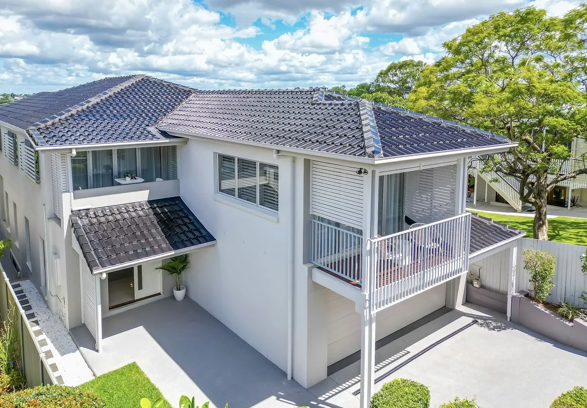 Two-storey white home exterior with balcony